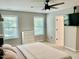Bright bedroom featuring a comfortable bed, ceiling fan, and private bathroom access at 166 Gulley Glen Dr, Garner, NC 27529
