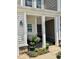 Inviting front porch with seating area and potted plants at 166 Gulley Glen Dr, Garner, NC 27529