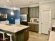 Modern kitchen with gray cabinets and a large island at 166 Gulley Glen Dr, Garner, NC 27529