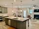 Open concept kitchen with island and adjacent living room at 166 Gulley Glen Dr, Garner, NC 27529