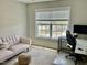 Functional home office with a desk, chair, and a view from a large window at 166 Gulley Glen Dr, Garner, NC 27529