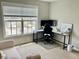 Home office with corner desk, comfortable chair, and plenty of natural light at 166 Gulley Glen Dr, Garner, NC 27529