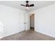 Simple bedroom with ceiling fan and double doors leading to hallway at 215 Dutchess Dr, Cary, NC 27513