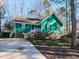 Green house with brick base, driveway, and landscaping at 215 Dutchess Dr, Cary, NC 27513