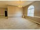 Bright dining room with an arched window and chandelier at 2281 Old Route 22, Kenly, NC 27542