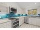 Modern kitchen with stainless steel appliances and blue tile backsplash at 232 Lakeview Dr, Sanford, NC 27332