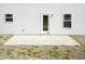 Backyard featuring a patio with a door, windows, exterior light, and white vinyl siding at 237 Hopewell Branch Ct, Smithfield, NC 27577