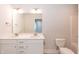 Modern bathroom with double vanity, bright lighting and toilet at 237 Hopewell Branch Ct, Smithfield, NC 27577