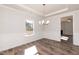 Bright dining room features elegant trim work, modern chandelier, and beautiful wood flooring at 237 Hopewell Branch Ct, Smithfield, NC 27577