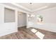 Bright dining room features elegant trim work, modern chandelier, and beautiful wood flooring at 237 Hopewell Branch Ct, Smithfield, NC 27577
