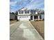 Charming two-story home features a spacious driveway, attached two-car garage, and inviting covered front porch at 237 Hopewell Branch Ct, Smithfield, NC 27577