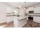 Modern kitchen features a granite island, stainless steel appliances, and ample cabinet space at 237 Hopewell Branch Ct, Smithfield, NC 27577