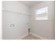 Practical laundry room with shelving and utility connections at 237 Hopewell Branch Ct, Smithfield, NC 27577