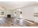 Open-concept space featuring a fireplace, modern lighting, wood floors and easy access to kitchen at 237 Hopewell Branch Ct, Smithfield, NC 27577