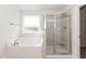 A luxurious main bathroom has a garden tub and a tiled shower with a glass door at 237 Hopewell Branch Ct, Smithfield, NC 27577