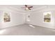 A sun-filled main bedroom with a ceiling fan, carpet, and a tray ceiling at 237 Hopewell Branch Ct, Smithfield, NC 27577