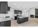 Modern kitchen featuring granite countertops and dark cabinetry at 250 Eason Creek Way, Clayton, NC 27527