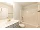 Bathroom features a tub with shower, gray vanity with white top, and white tiled floor at 251 Hopewell Br Ct, Smithfield, NC 27577