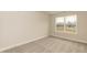 Bedroom with plush gray carpet and a window overlooking a new construction community at 251 Hopewell Br Ct, Smithfield, NC 27577
