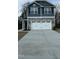 Exterior shows a two-car garage and a two-story home with gray siding and stone accents at 251 Hopewell Br Ct, Smithfield, NC 27577