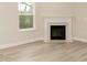 Bright living room featuring a fireplace, hardwood floors, and neutral walls at 251 Hopewell Br Ct, Smithfield, NC 27577
