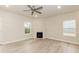 Open-concept living room with hardwood flooring, fireplace, and natural light at 251 Hopewell Br Ct, Smithfield, NC 27577