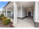 Front porch with rocking chairs and gray exterior at 2515 Impulsion Dr, New Hill, NC 27562