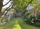 Fenced backyard featuring lawn, blue hydrangea bushes, and a border of foliage at 2612 Academy St, Sanford, NC 27332