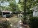 Park-like backyard offers a secluded retreat with lush greenery and an outbuilding at 2612 Academy St, Sanford, NC 27332