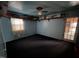 Bedroom with blue painted walls and ceiling with miniature buildings on decorative shelving at 2612 Academy St, Sanford, NC 27332
