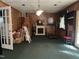 Bonus room with green carpet, fireplace, and lots of clutter at 2612 Academy St, Sanford, NC 27332