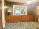 Den shows wood paneling and built in cabinetry at 2612 Academy St, Sanford, NC 27332