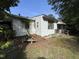 Exterior of white home with covered front porch and bench in the front yard at 2612 Academy St, Sanford, NC 27332