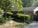 Charming brick home featuring a well-manicured front yard and a vintage lamppost at 2612 Academy St, Sanford, NC 27332