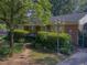 Charming brick home featuring a well-manicured front yard and a vintage lamppost at 2612 Academy St, Sanford, NC 27332
