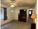 A cozy living room features neutral walls, a ceiling fan, and views into the hallway at 2612 Academy St, Sanford, NC 27332