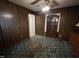 Living room view features paneled walls, ceiling fan with lights, and doorway at 2612 Academy St, Sanford, NC 27332
