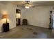 The living room has neutral walls and carpet with a ceiling fan and access to the kitchen at 2612 Academy St, Sanford, NC 27332