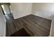 Living room with grey wood-look floors and access to other rooms at 2801 O'Shanter Pl, Raleigh, NC 27604