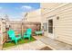 Cozy backyard featuring faux grass, two bright-colored chairs, a grill, and a stylishly paved patio area at 30 Cheltenham Dr, Clayton, NC 27520