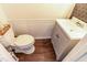 Bathroom featuring modern fixtures, stylish vanity, and charming wainscoting at 30 Cheltenham Dr, Clayton, NC 27520