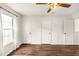 Bright bedroom with hardwood flooring, three closets, and a large window providing natural light at 30 Cheltenham Dr, Clayton, NC 27520