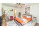 Bedroom with queen-size bed, ceiling fan, and red electric fireplace at 30 Cheltenham Dr, Clayton, NC 27520