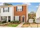 Charming townhome showcasing a well-maintained brick facade and lovely landscaped front yard at 30 Cheltenham Dr, Clayton, NC 27520