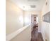 Bright hallway with hardwood floors, white trim, and natural light streaming through the decorative window at 30 Cheltenham Dr, Clayton, NC 27520