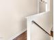 Hallway with hardwood flooring and white walls leading to the second story of the house at 30 Cheltenham Dr, Clayton, NC 27520