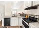 Bright and modern kitchen featuring granite countertops and stainless steel appliances at 30 Cheltenham Dr, Clayton, NC 27520