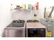 Efficient laundry area with modern appliances and organized shelving for storage and household supplies at 30 Cheltenham Dr, Clayton, NC 27520