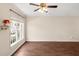 Bright living room featuring hardwood floors, a large window, and a ceiling fan at 30 Cheltenham Dr, Clayton, NC 27520