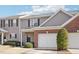 Two-story townhouse featuring brick and siding exterior, two-car garage at 3526 Londonville Ln, Raleigh, NC 27604